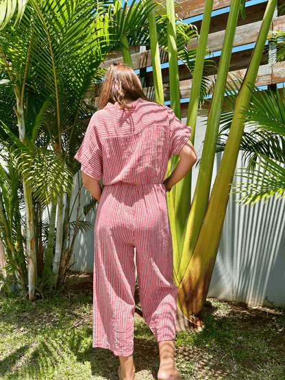 Profitez de cette combinaison 3/4 à rayures framboise et beige avec des boutons sur le devant. Parfaite pour un look estival chic et décontracté. Commandez en ligne et bénéficiez de la livraison gratuite.